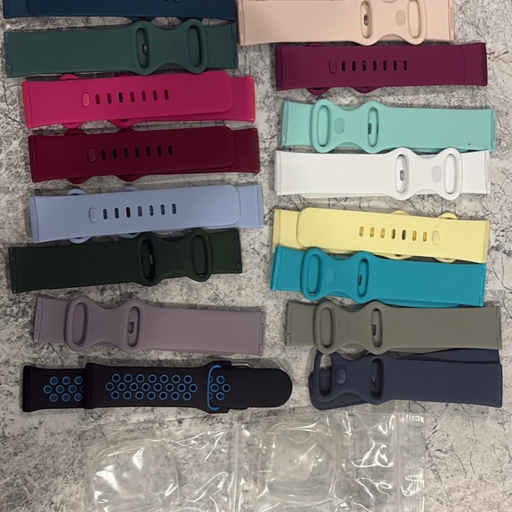 Fitbit Versa 3 with 16 various colored bands and 2 protective covers